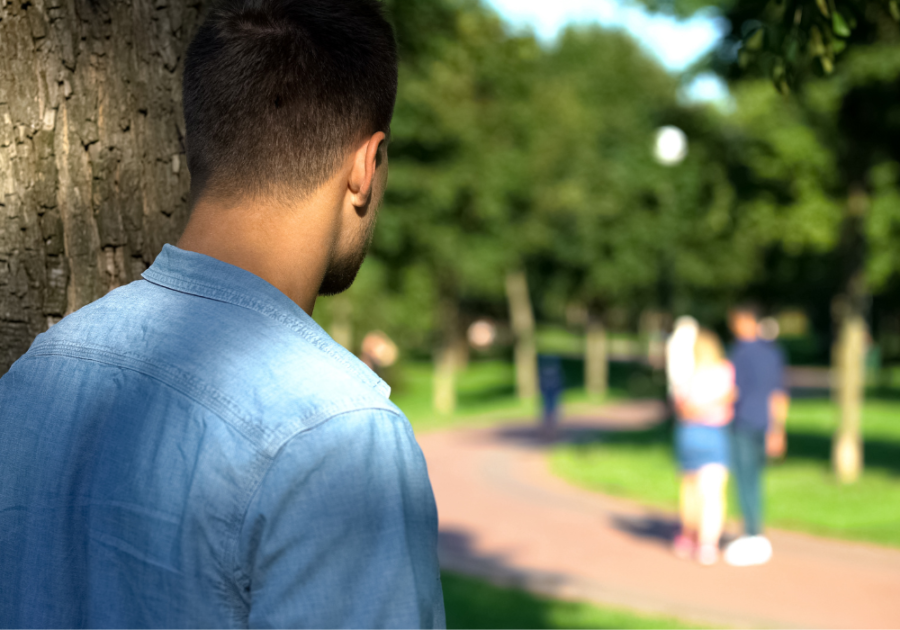 man watching over a couple while hiding signs he doesn't want anyone else to have you