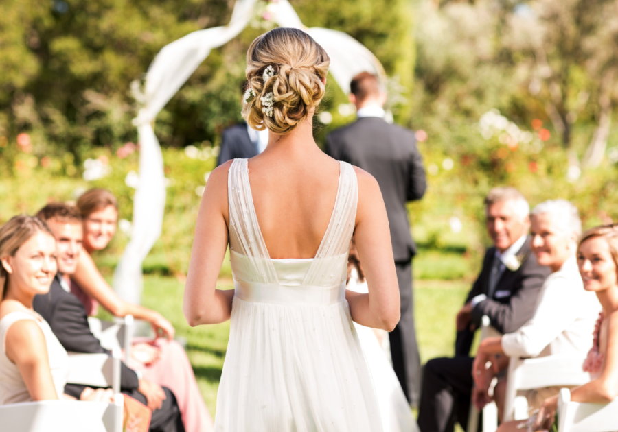 bride walking in the aisle in a garden wedding letter to husband on wedding day 