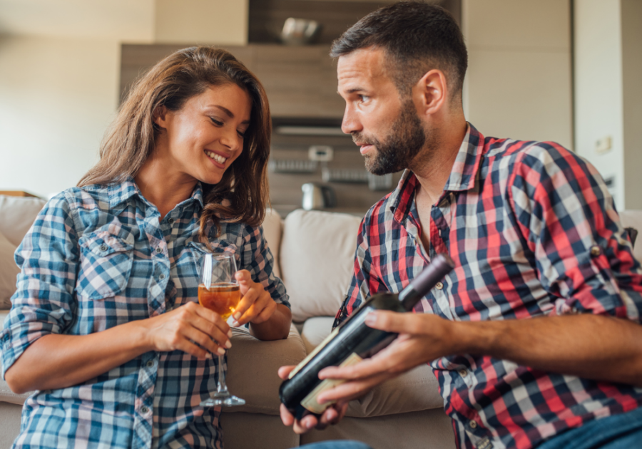 couple looking at bottle of wine Date Night Ideas for Married Couples