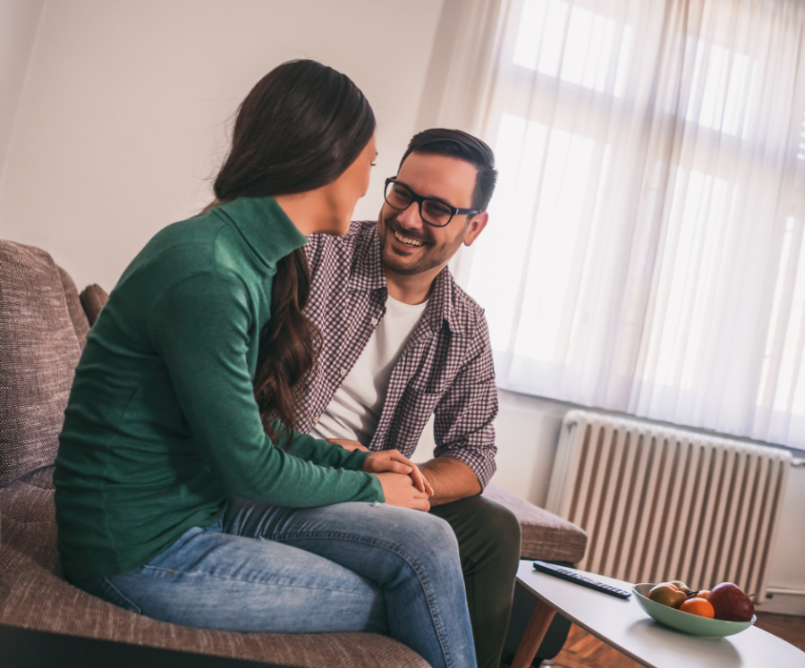 couple sitting on sofa talking Examples Of Healthy Boundaries In Relationships