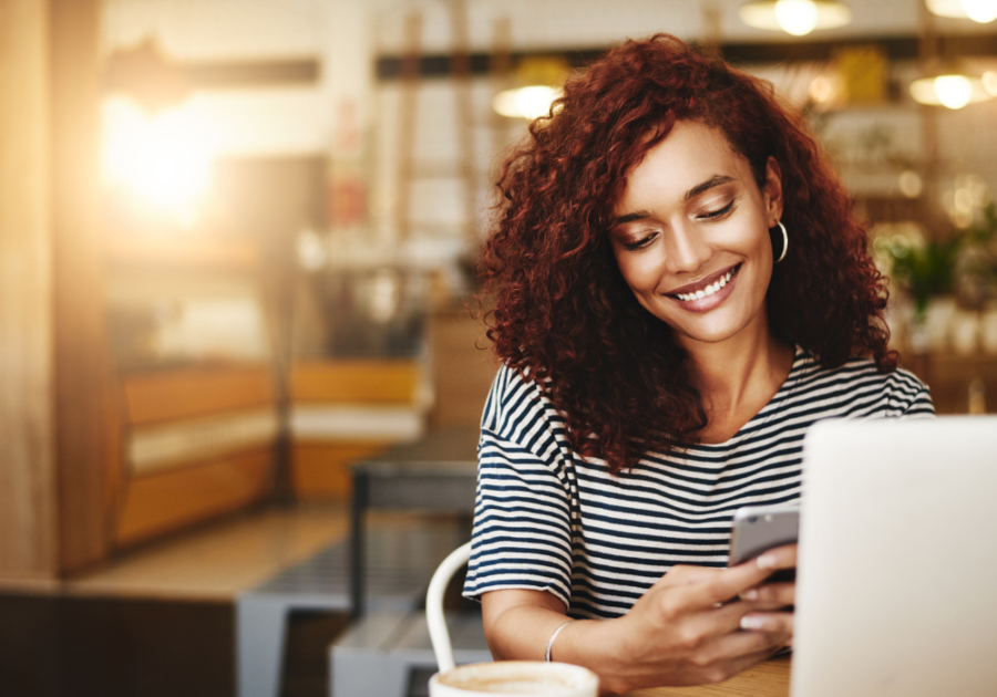  woman smiling looking at phone, love letters to make him cry
